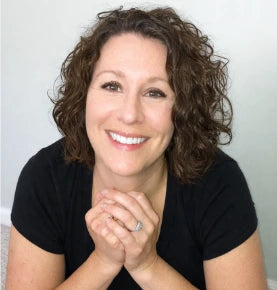 Jennifer Blair, founder of ThistleScotch, smiling with her hands clasped.